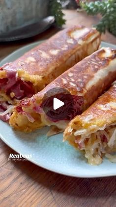 the sandwich is cut in half and ready to be eaten on the plate with other food items