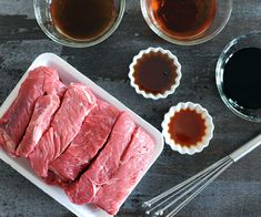 raw meat and sauces on a table