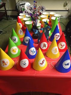 a red table topped with lots of party hats