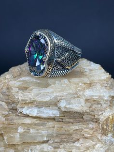 Mystic Topaz Silver Men's Ring | Handmade | 20g | Free Shipping 🔹 Discover the allure of our handcrafted Mystic Topaz Stone ring, designed for those who appreciate elegance and sophistication. This remarkable men's ring, weighing a solid 20 grams, features a dazzling Mystic Topaz gemstone that captures and reflects light in a mesmerizing array of colors. 🔹 Key Features: *Material: Premium Silver *Gemstone: Mystic Topaz *Weight: 20 grams *Design: Handcrafted for unique beauty *Guarantee: 1 year Handmade Mystical Iridescent Ring, Mystical Handmade Iridescent Ring, Handmade Iridescent Mystical Ring, Spiritual Silver Topaz Gemstone Ring, Mystical Stamped 925 Rings For Gifts, Spiritual Silver Topaz Ring, Mystical Stamped 925 Rings As Gift, Mystical Iridescent Sterling Silver Rings, Iridescent Spiritual Rings For Anniversary