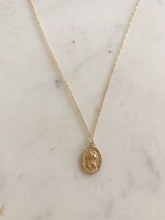 Beautiful for any layering look or gorgeous on its own!  Saint Christopher is widely recognized as the saint of travel. Many people across the world carry this medallion close to protect them on their journeys. Whether you're back packing across the globe, or just making your way home after a long day - be protected by St. Chris!  Gold filled coin and gold filled chain, made to live in!  Measures on 16 inch chain with extender to bring it to 18 inches in order to find your perfect length for lay Gold Medallion Necklace Gift, Saint Christopher Necklace, Layered Coin Necklace, St Christopher Necklace, Travel Necklace, Saint Christopher, Necklace Layering, Coin Necklace, Gold Filled Chain