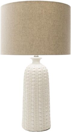 a white table lamp with a beige shade