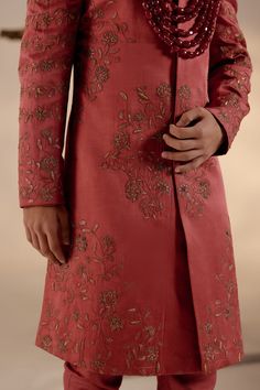 Red Ochre Sherwani Set | Jatin Malik Introducing our stunning red ochre hand-embroidered sherwani, adorned with exquisite tone-on-tone resham work, intricate gold zari, and dabka details, embodying timeless elegance and sophistication. Paired with an ombre hand-embroidered stole and a tone-on-tone safa, this ensemble exudes refined charm and impeccable style. Perfect for those seeking to make a statement with their attire, this sherwani set beautifully combines tradition with contemporary flair, making it ideal for special occasions and celebrations. Included in purchase: Sherwani, Kurta, Churidar, Stole, Safa Product Specification Color: Red Fabric: Linen silk Occasion: Engagement, Wedding, Bridal, Reception Style: Sherwani, Kurta, Churidar, Safa, Stole Care: Dry Clean Work: Hand Embroide Jatin Malik, Embroidered Sherwani, Blouse Yoke, Resham Work, Red Ochre, Luxury Footwear, Indian Wedding Outfits, Silk Embroidery, Red Fabric