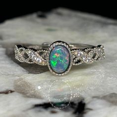 A Majestically Crafted Ring With A Bright Black Welo Opal. Type - Black Crystal Location - Welo, Ethiopia Size - 6mm X 4mm X 2mm Weight - 0.25 Cts Cut - Oval Pattern - Patchwork Rolling Flash Brightness - B4 Metal - .925 Sterling Silver Ring Size - Adjustable Full Video - Https://Www.Theopalsource.Com/Product-Page/Beautiful-Color-Patchwork-Black-Ethiopian-Custom-Made-Opal-Ring Shiny Rings, Opal Ring, Welo Opal, Black Crystals, Opal Rings, Women Accessories Jewelry, Womens Jewelry Rings, Product Page, Sterling Silber