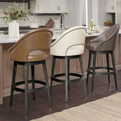 three bar stools in front of a kitchen island