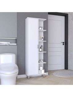 a white toilet sitting next to a tall cabinet