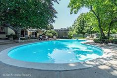 an empty swimming pool surrounded by trees