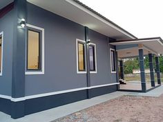 a house that is painted blue and has windows on the front, and side of it