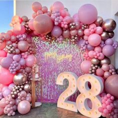 a large balloon arch with the number twenty two in front of it and balloons all around it