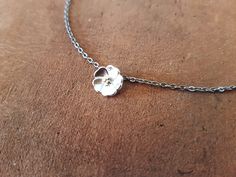 "This delicate necklace features a tiny sakura (cherry blossom) flower pendant. Very feminine and elegant. The pendant is 0.8mm in size and has a lovely satin finish. The stainless steel chain is 45cm + 5cm long (18\" + 2\"). The necklace fastens with a lobster claw clasp." Delicate Flower Pendant Necklace, Delicate Adjustable Flower Necklace With Delicate Chain, Dainty Flower Necklace With Delicate Chain, Adjustable Delicate Flower Necklace With Delicate Chain, Dainty Adjustable Flower Pendant Necklace, Delicate Flower Shaped Necklace With Delicate Chain, Delicate Blossom Flower Necklace, Delicate Blossom Flower Pendant Necklace, Delicate Adjustable Flower Pendant Necklace