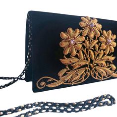 "Exquisite black velvet evening bag, hand embroidered in the zardozi style with copper colored metallic flowers and embellished with genuine amethysts, to create an opulent, dazzling 3D effect. The matte copper threads change to shiny at the tips of the flowers and the leaves. Add an eye-catching pop of color, texture and sparkly bling to your overall party look. It is just the right size to hold your essentials for the night - phone, credit cards, money, keys and lipstick. The shoulder strap ke Hand Embellished Black Evening Bag, Black Hand Embellished Evening Bag, Elegant Hand Embellished Black Bag, Elegant Black Hand-embellished Bag, Luxury Hand Embellished Black Evening Bag, Luxury Black Hand Embellished Evening Bag, Luxury Hand-embellished Black Evening Bag, Elegant Gold Evening Bag With Floral Embroidery, Gold Evening Bag With Zari Work