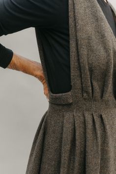 the back of a woman's dress with her hands on her hips