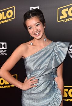 a woman in a silver dress posing for the camera