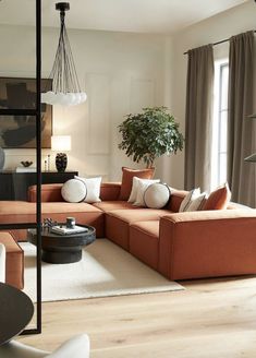 a living room filled with furniture and a potted plant