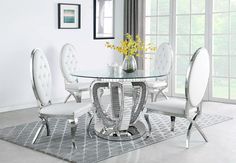 a glass dining table with white chairs and a vase filled with yellow flowers on top