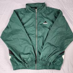 Vintage 1990s Adidas Green Black White Tuck Away Hood Windbreaker  In great condition  Light staining/ yellowing white stripes Large  27.5 x 26 Pit to Pit  Any questions feel free to reach out! Luxury Green Hooded Windbreaker, Green Sporty Windbreaker, Luxury Green Nylon Windbreaker, Adidas Vintage, Sun Valley, White Stripe, Gender Neutral, Art Collection, Jackets & Coats