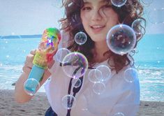 a woman on the beach with soap bubbles