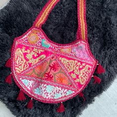 Item Embroidered Heart Shaped Shoulder Festival Ethic Bag. Features Colorful Metallic Threading In Embroidery Colors Include Red Green Purple Gold Pink Orange And Teal On Muted Red Or Pinkish Red. Gray Clean Unused Cotton Lining Full Top Zipper Closure Tassels Trim The Baseline Lightweight Folds Travel Friendly Double Straps How & Where Festival Beach Bag Vacation Travel Beach Summer Costume Size & Measurements Strap 1.5” X 29” Bag 17” X 14” Condition Like New, Flawless We Love Offers! Tags Trav Festive Pink Embroidered Shoulder Bag, Festive Multicolor Bag With Intricate Embroidery, Traditional Pink Shoulder Bag, Festival Multicolor Embroidered Hobo Bag, Red Floral Embroidered Tote Shoulder Bag, Red Floral Embroidery Tote Shoulder Bag, Red Embroidered Bag, Traditional Pink Tote Bag, Pink Shoulder Bag For Festival