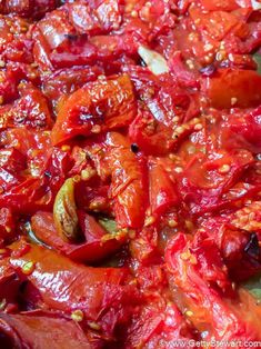 red peppers are being cooked in a pan