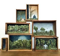 four wooden boxes with miniature paintings on them