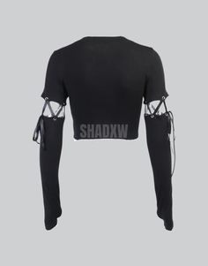 Type: Crop top Design: Gothic, techwear Ultra-resistant crop top: Designed with the best materials for a comfortable wear. Breathable materials: This crop top is made of polyester, spandex and nylon. Suitable for women Machine washable: 30 °C (86 °F) Long Sleeve Gothic Crop Top Embrace the core essence of techwear and darkwear with our alluring Long Sleeve Gothic Crop Top. Designed to be the epitome of edgy street style. The obsidian shades of the Long Sleeve Gothic Crop Top beckon the enigmatic hearts seeking to intertwine the modern urban style with the timelessly mystic Gothic aesthetic. The dark canvas of the crop top perfectly contrasts with the logo on the bust, embodying a blend of minimalism and boldness. Adorning a hood that serves as a veil to the unseen, the Gothic Crop Top adds Fitted Black Techwear Top, Fitted Futuristic Black Top, Futuristic Fitted Black Top, Cropped Nylon Stretch Tops, Black Rave Crop Top, Black Rave Crop Top For Streetwear, Black Stretch Rave Tops, Black Stretch Tops For Rave, Black High Stretch Crop Top For Streetwear