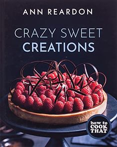 a cake with raspberries on top and the title, crazy sweet creations how to cook that