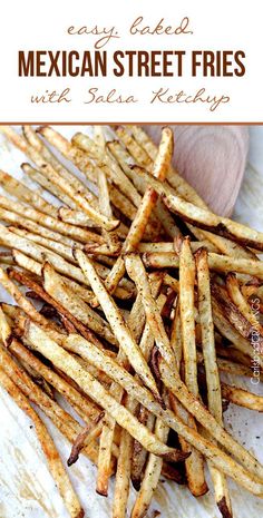 homemade mexican street fries with salsa ketchup on a cutting board and text overlay that reads easy baked mexican street fries with salsa ketchup