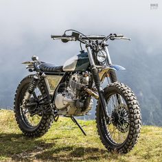 a motorcycle parked on top of a grass covered field