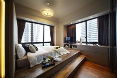 a large bed sitting in the middle of a bedroom next to a tv on top of a wooden shelf