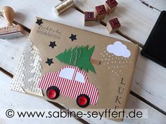 a cardboard box with a christmas tree on it and some rubber stamps next to it