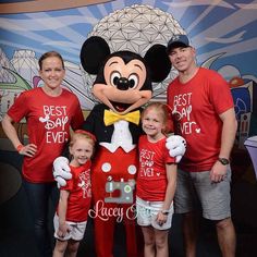 the family is posing for a photo with mickey mouse