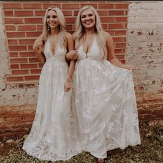 two women standing next to each other wearing white dresses and holding hands in their pockets