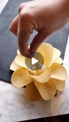 a person is placing something in the center of a flower