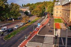 an aerial view of a city street with cars driving on it