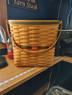 a brown basket sitting on top of a wooden desk