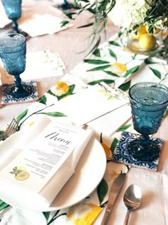 the table is set with plates, silverware and napkins for an elegant dinner