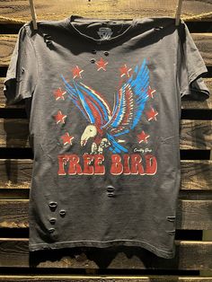 Country Deep Free Bird 22 vintage distressed 1980's unisex T shirt available in faded black 40 Singles Jersey 100% Cotton Premium quality ringspun and compacted cotton Fine Cotton Jersey that is pigment dyed for a more vintage look Features tears and destroyed features at neck and on body Each piece is unique as this process is done by hand! 3.8 oz Made In USA Every garment dye item can be a slightly different shade in color since this is a laundry dye process. Enjoy its unique quality! SIZE CHA Edgy Faded Distressed T-shirt, Band Merch Stonewashed T-shirt For Streetwear, Edgy Distressed Faded T-shirt, Edgy Stonewashed T-shirt In Washed Black, Edgy Stonewashed Black T-shirt, Stonewashed Cotton T-shirt With Edgy Style, Edgy Stonewashed Cotton T-shirt, Stonewashed Cotton T-shirt In Edgy Style, Edgy Black Stonewashed T-shirt