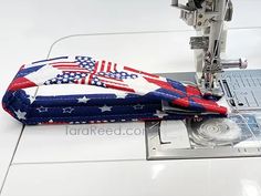 an american flag quilted on top of a sewing machine with the needle facing down