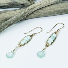 Our Seascape Stack earrings are the perfect beachy accessory for adding a pop of color to your wardrobe. Faceted Peruvian Opal and Chalcedony gemstones boast gorgeous sea green colors and are accented with 14k gold filled wire wrapping. Length: 2" Peruvian Opal and Chalcedony 14k gold filled Handmade 14k Gold Filled Jewelry For The Beach, Beach Wire Wrapped Drop Earrings, Bohemian 14k Gold Filled Jewelry For Beach, Handmade 14k Gold Filled Earrings For Beach, Handmade 14k Gold-filled Earrings For Beach, Handmade 14k Gold Filled Beach Earrings, Turquoise Wire Wrapped Earrings For Beach, Bohemian Turquoise 14k Gold Filled Earrings, Green Bohemian 14k Gold Filled Earrings