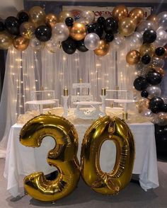 the table is set up with balloons and decorations for an 30th birthday party or celebration