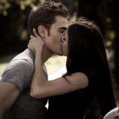 a young man and woman kissing each other