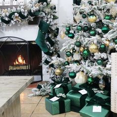 a decorated christmas tree in front of a fireplace