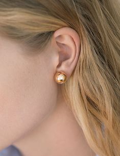 hollow 14k yellow gold sphere stud earring. each sphere sold individually. available in 3 sizes. 12mm stud pictured on model. made in los angeles. kathleen whitaker Kathleen Whitaker, Floating Earrings, Gold Sphere, Cascade Necklace, Hammered Hoop Earrings, Ear Clips, Affordable Jewelry, Simple Earrings, Stylish Jewelry