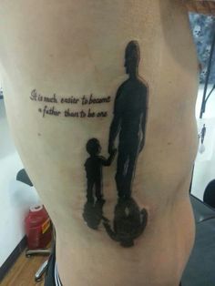 a person with a tattoo on their stomach that says it is much easier to become a father than to be one