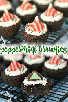 peppermint brownies with white frosting and candy canes are on a cooling rack