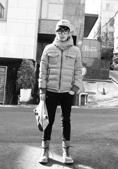 black and white photograph of a man standing in the street