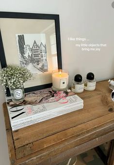 a wooden table topped with books and candles