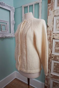 A classic women's cardigan sweater, in a soft ivory white acrylic. It has a unique wide pattern of traditional cable knit down the front. It closes up the front with a row of really unique swirly plastic buttons. The sweater is soft and comfy, not stiff at all. No damage or issues. Please check measurements carefully. Condition: Very Nice Vintage Tag: 100% Acrylic Size L Measurements in inches.... Length: 23.5 Chest: 19 ✩ Because you don't want to miss a thing, follow @heartkeyologie on Facebook Retro Cream Winter Cardigan, Cheap Vintage Cream Cardigan, Vintage White Crew Neck Cardigan, Cream Fitted Vintage Cardigan, Vintage Cream Embroidered Cardigan, Cardigan Vintage, Boho Sweater, Cardigan Sweaters For Women, Womens Cardigan