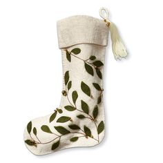 a white christmas stocking with green leaves on it