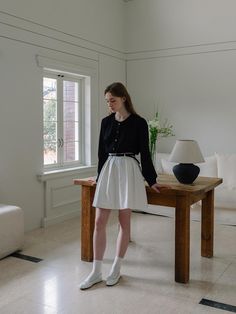 This skirt is designed with a flared silhouette, accentuated by neat pleats that add volume and movement. It sits at the waist and includes a contrasting belt, which not only secures the fit but also adds a stylish element. The fabric appears crisp and lightweight, suitable for a smart-casual look or formal occasions. The skirt's hemline is cut straight across, which complements the structured pleating.- The contrasting belt is a striking addition that defines the waist and offers a visual break in the monochromatic scheme.- With its classic style, the skirt can be paired with both fitted and loose tops for different looks.- The fabric and construction suggest that it is easy to care for, while also holding its shape throughout wear. Elegant Spring Pleated Skirt With Belt, Elegant Pleated Skirt With Belt, Elegant Relaxed Skirt With Belt, Elegant Skirt With Belt, Belted Flared Pleated Skirt For Workwear, Belted Flared Pleated Skirt, Belted Pleated Skirt For Work, Casual Belted Pleated Skirt For Work, Relaxed Fit Belted Pleated Skirt